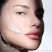 Woman's face with Helena Rubinstein REPLASTY cream and innovative bandage texture on her cheek.